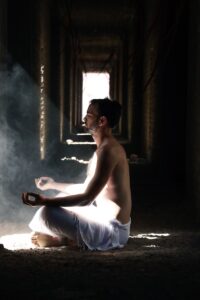 man meditating inside building