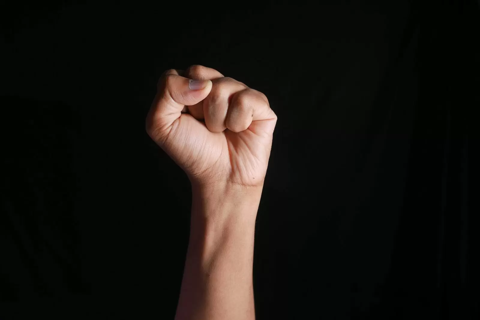 persons right hand doing fist gesture